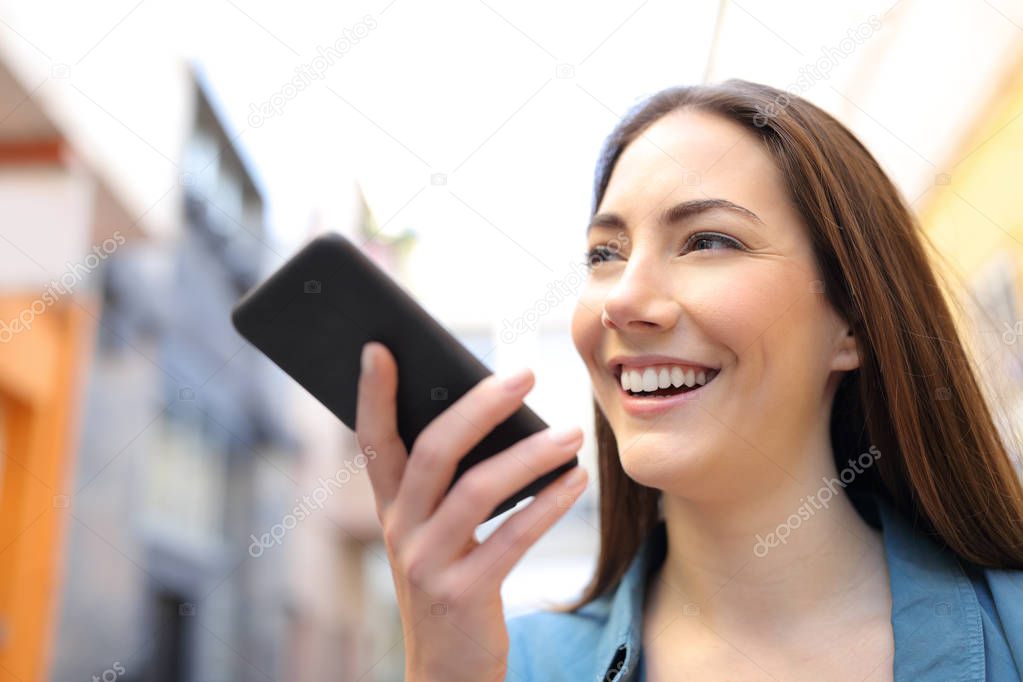 Happy girl using voice recognition app on smart phone
