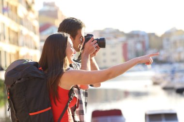 Backpackers taking photos on summer vacation clipart