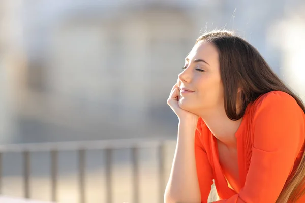 Mujer relajada en naranja meditando con los ojos cerrados —  Fotos de Stock