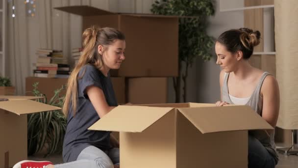 Two Happy Roommates Moving Home Night Unboxing Belongings — Stock Video