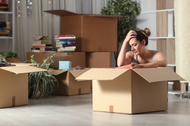 Sad evicted tenant moving home boxing belongings clipart