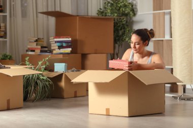 Ciddi kadın gece eşyalarını unboxing eve hareket