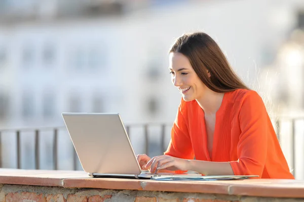 Happy self employed working with a laptop in a balcony — Stock Photo, Image
