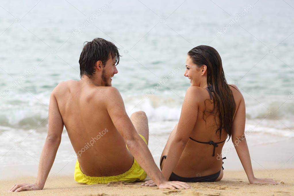 Couple in love looking each other on the beach