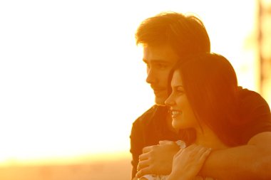Couple in love contemplating views at sunset clipart