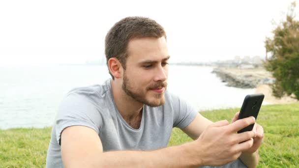 Excited Man Checking Smart Phone Messages Outdoors — Stock Video