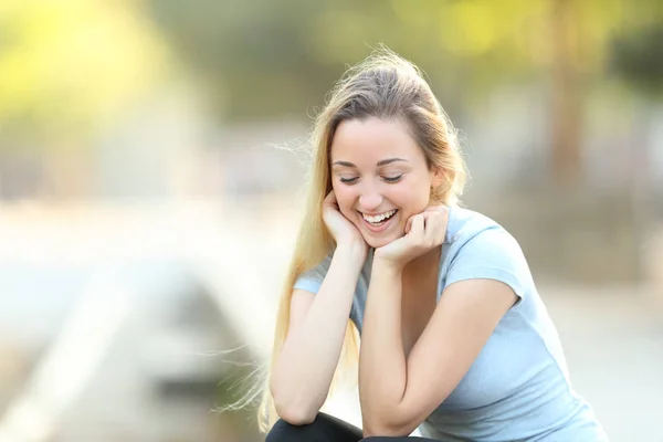 Candid teenage girl laughing looking down — Stock Photo, Image