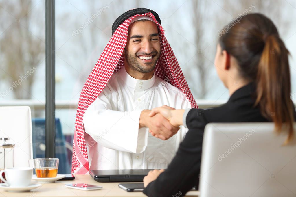 Arab businessman and marketer handshaking