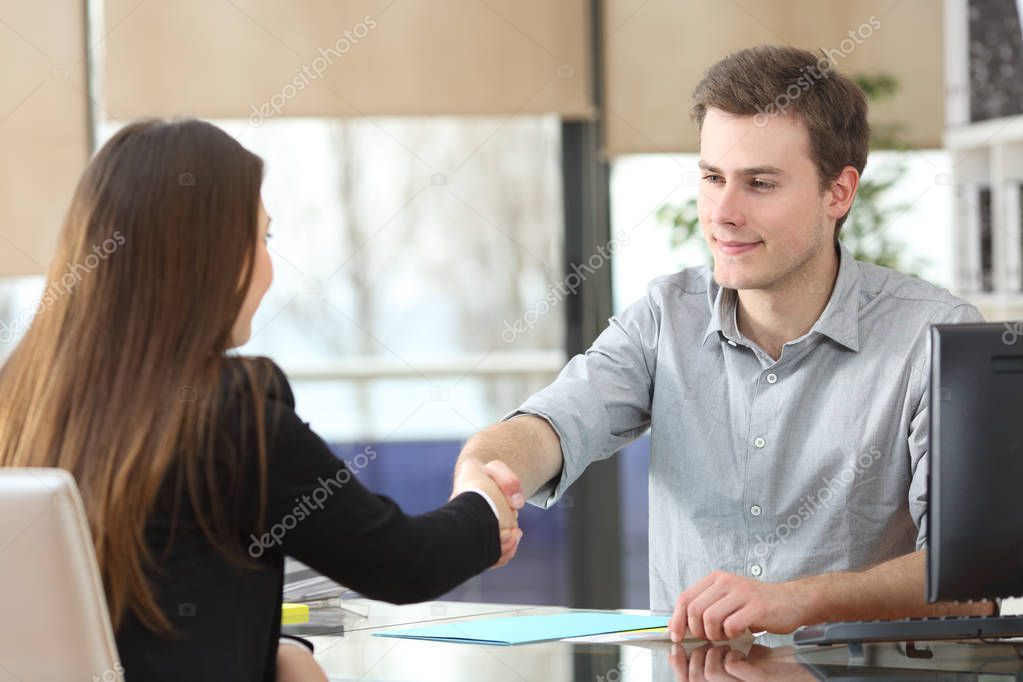 Serious businesspeople handshaking at office