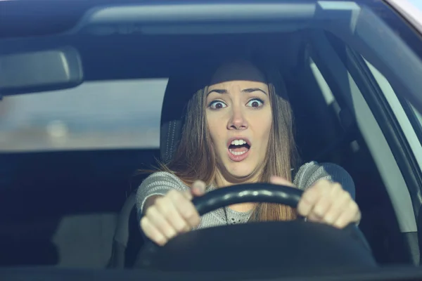Scared driver driving a car before an accident — Stock Photo, Image