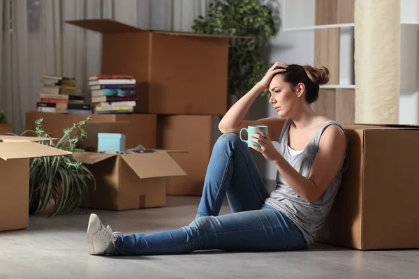 Sad evicted tenant moving home complaining on the floor — Stock Photo, Image