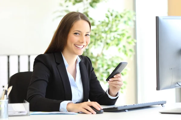 Happy businesswoman posing holding smart phone at office — Stock Photo, Image