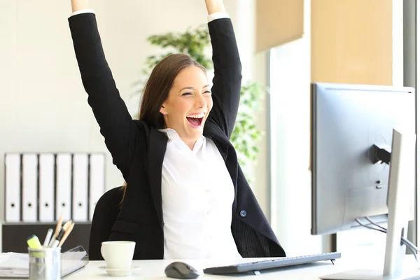 Excited businesswoman checking good news on computer Royalty Free Stock Images