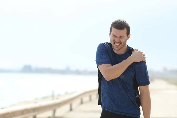 Sportsman complaining suffering shoulder ache after sport — Stock Photo, Image