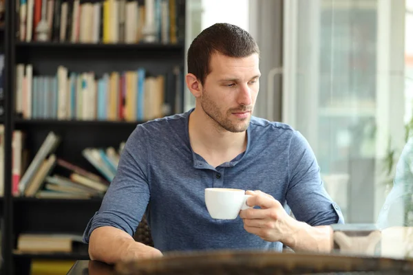 Pensive sad man looks away in a coffee shop — Stock Photo, Image