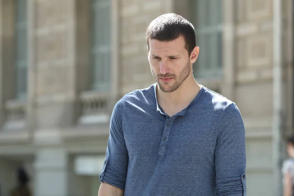 Sad adult man walking looking down in the street — Stock Photo, Image