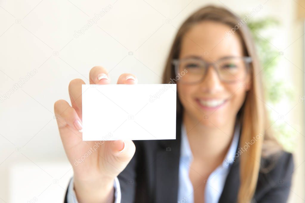 Happy businesswoman showing blank card at office