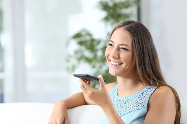 Happy woman uses voice recognition on mobile phone — Stock Photo, Image