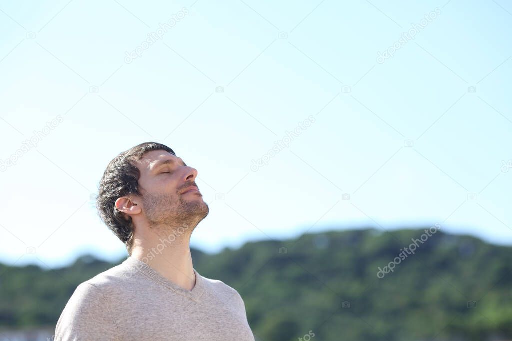 Man breathing outdoors fresh air in the mountains