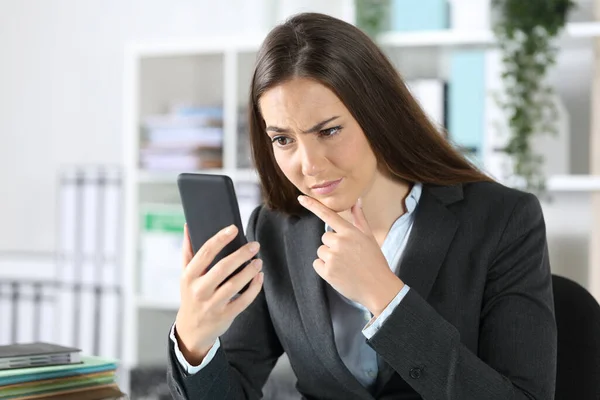 Suspicious Executive Woman Checking Smart Phone Sitting Desk Office — Stock Photo, Image