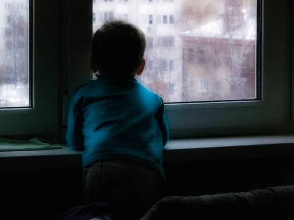 Little Boy Looks Out Window Waiting Spring Something Snowing Cold — Stock Photo, Image