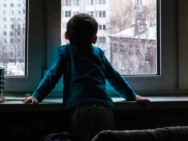 Little Boy Looks Out Window Waiting Spring Something Snowing Cold — Stock Photo, Image