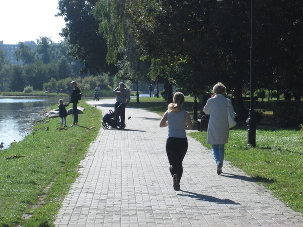 Girl runs in the park on a sunny summer day