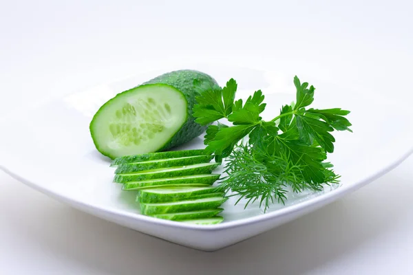 Cucumber on a white plate served for food, isolated