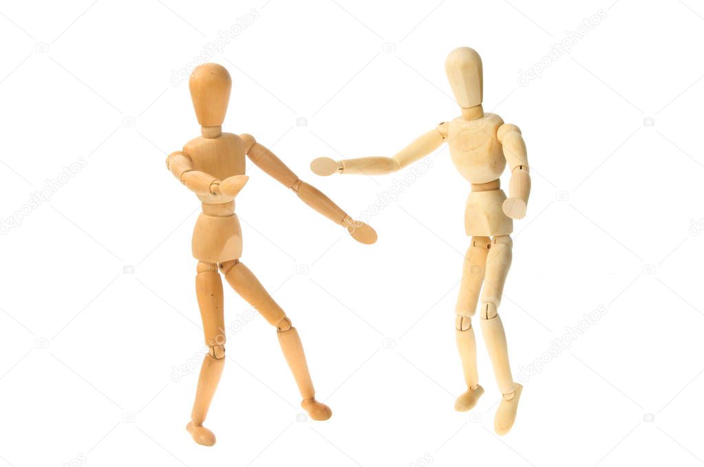 Two wooden artist's manikins dancing, isolated against white