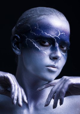 young woman with lightning face art on black background. Female lightning design body art. Blue silver face art. clipart