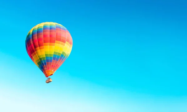 Colorful hot air balloon on isolated blue sky background. hot air balloon flying over at fairy chimneys in Nevsehir, Goreme, Cappadocia Turkey. Hot air balloon flight at spectacular Cappadocia Turkey.