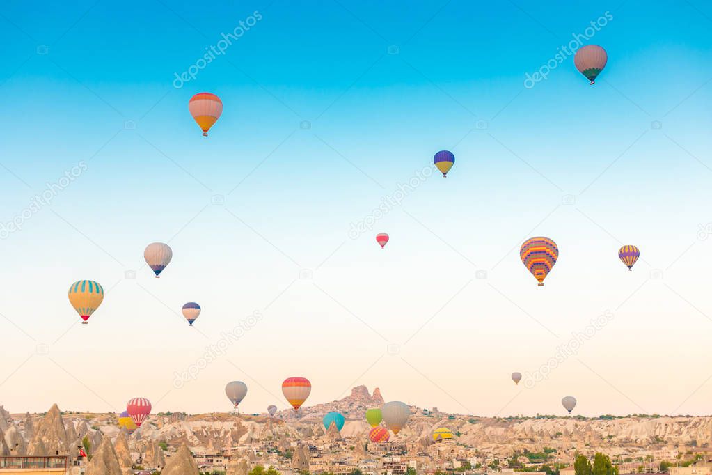 Colorful hot air balloons flying over at fairy chimneys in Nevsehir, Goreme, Cappadocia Turkey. Hot air balloon flight at spectacular Cappadocia Turkey.