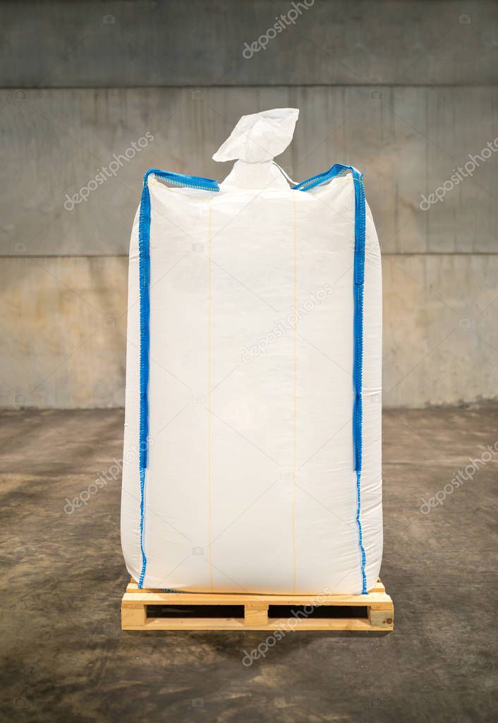 White sack bag at large warehouse in modern factory. Packaging in factory or warehouse