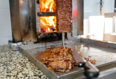 Geleneksel Türk Donör Kebap eti. Şef bıçak donörü, shawarma ya da jiroskopla kesiyor. Türk, Yunan ya da Ortadoğu tarzı kebap yapan kebapçılar ızgaranın önüne tükürüyor.