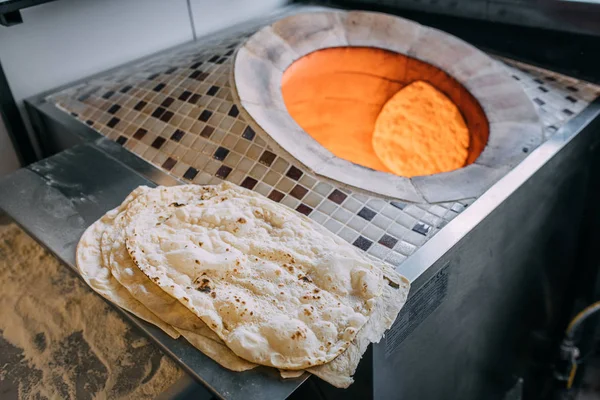 伝統的なトルコのラマダーンフードのピタ パイド ラバッシュ またはユフカパンを火で焼く石のオーブンで焼く タンディールまたはタンドア とも呼ばれる — ストック写真