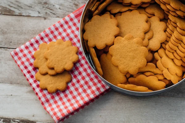 Stack of sugar cookies biscuits on white rustic wooden table from top view. These are yellow delicious tasty yummy cookies biscuits for new year or christmas celebrations at winter time.