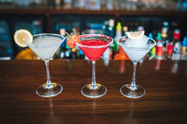 Refreshed exotic frozen tropical Margarita cocktails with lemon, strawberry and citron on the bar desk. This is summer exotic colorful cocktails