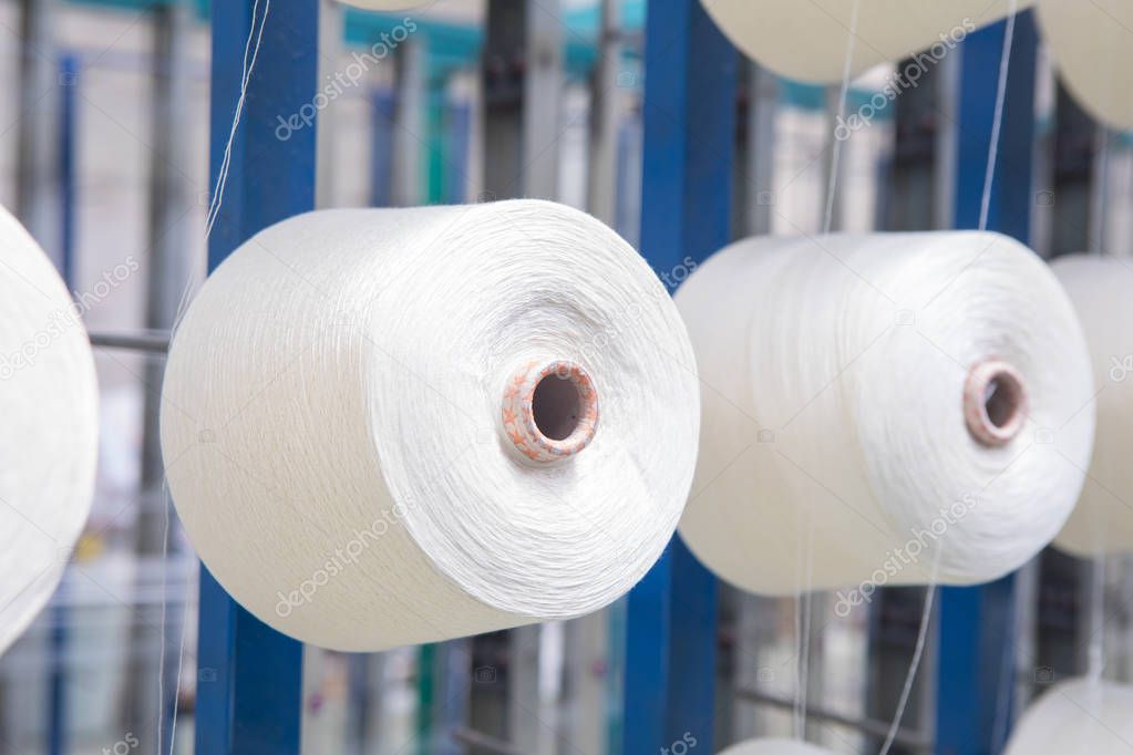 Close up yarn threads spools bobbin tubes. Textile industry fabric concept background image.