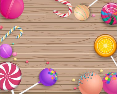 Bej ahşap arka plan ile renkli lolipop.