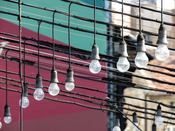 Hanging light bulbs in terrace of abandoned caffe.