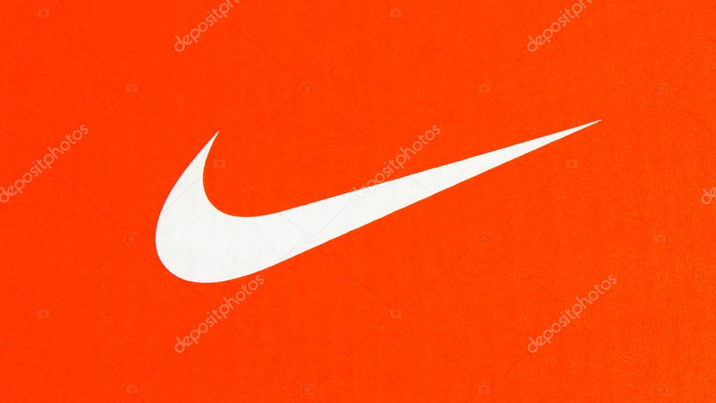 Belgrade, Serbia -  July 11 2019. Nike swoosh. Nike white logo on cardboard orange sneakers box.