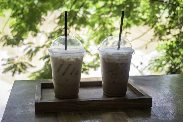 Iced coffee on wooden outdoors table — Stock Photo, Image