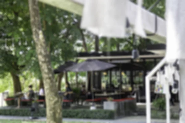 Blur restaurant outdoor furnitures in garden — Stock Photo, Image