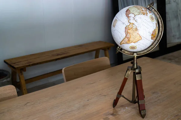 Vintage globe decorated on top of the table, stock photo