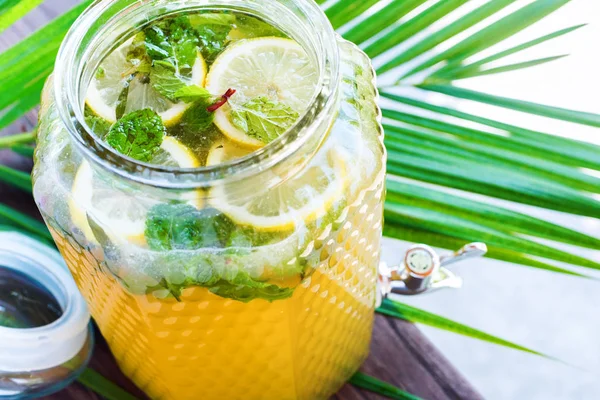 Jar lemonade fresh lemon sliced leaves mint Ice cold useful juicy beverage in hot weather Refreshing drink Summer time
