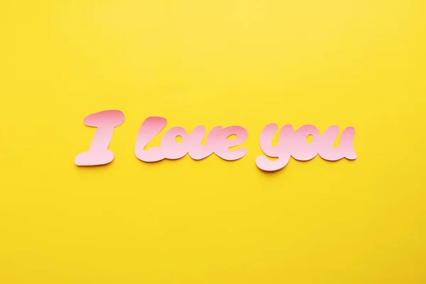 Phrase I love you from pink paper yellow background — Stock Photo, Image