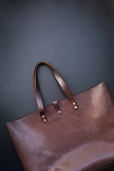 Elegant luxury leather brown bag dark background