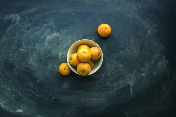 Tangerines in bowl on dark background. Super food