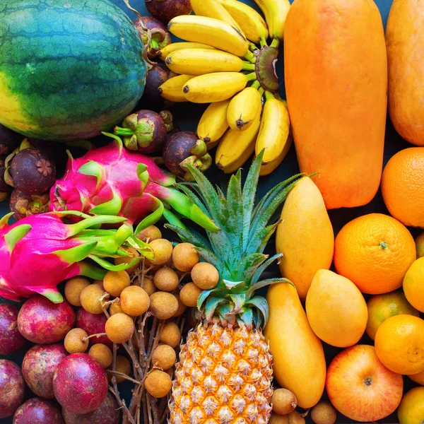 Set fresh organic exotic tropical fruit on dark — Stock Photo, Image