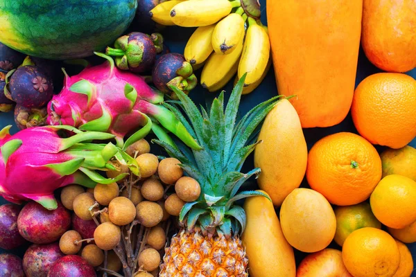 Set fresh organic exotic tropical fruit on dark — Stock Photo, Image